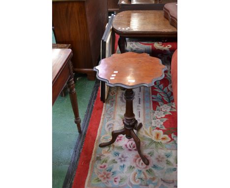 A late Victorian tripod table, shaped top, turned column, underfinial cabriole legs.