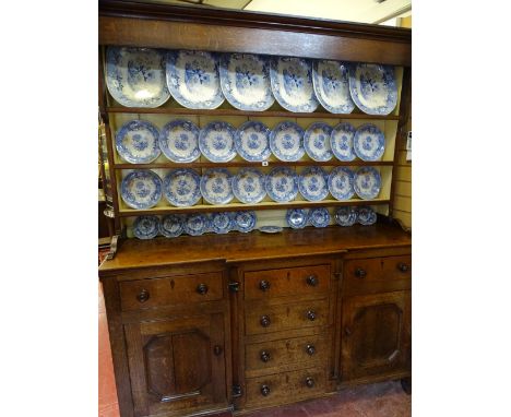 Late 19th Century oak Anglesey dresser having a three shelf rack over a breakfront base having three opening top drawers, thr