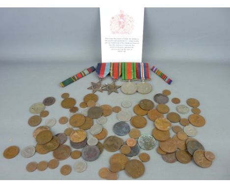 Group of four un-named WWII military medals with a quantity of mainly British, vintage and later coinage
