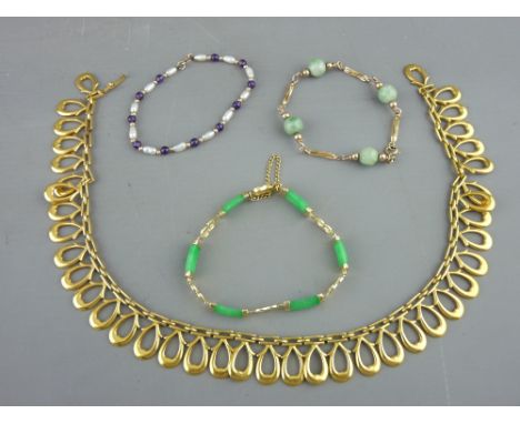 Large yellow metal necklet of four shaped oval drops, a nine carat gold and jadeite bracelet with safety chain, 9.3 grms, a n