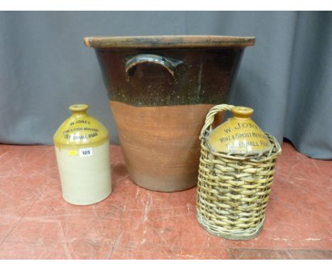 Two stoneware W Jones, Wine &amp; Spirit Merchant flagons and a vintage pottery egg crock