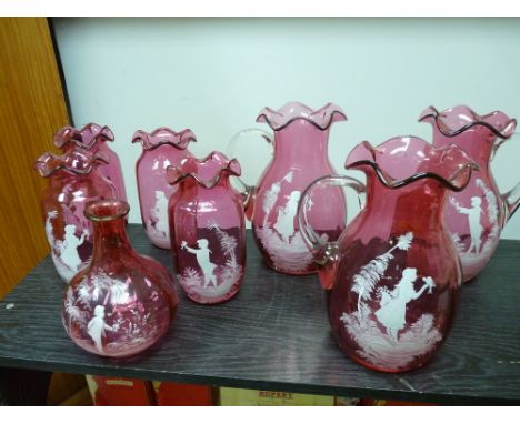 Collection of cranberry glass Mary Gregory style vases and jugs (eight), to include three 21 cms high water jugs, a 16 cms hi