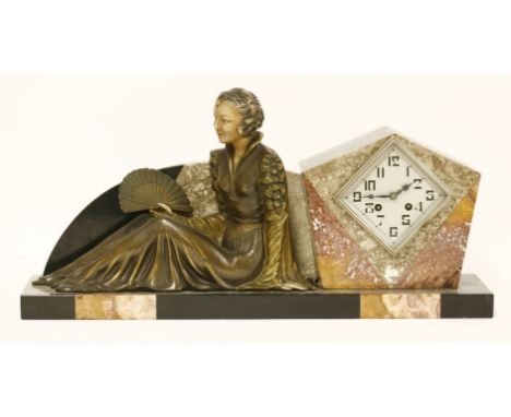 An Art Deco marble mantel clock,the lozenge-shaped dial mounted to the side, with a spelter figure of lady holding a fan,58cm