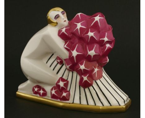 A Limoges porcelain table lamp,modelled as a lady kneeling and holding a bunch of flowers,18cm wide