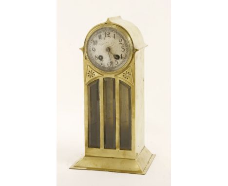 A Secessionist brass mantel clock,with a silvered dial mounted in an arched case with glass panels,25.5cm high
