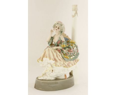 A Goldscheider pottery lamp base,modelled as a lady powdering her face, inscribed 'XXVII, D2' and printed 'PH', extensively r
