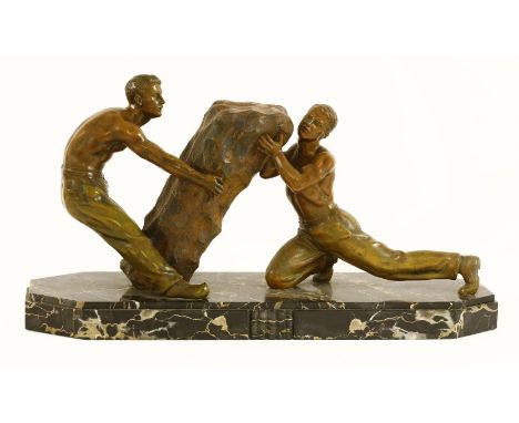 An Art Deco spelter and marble centrepiece,modelled as two men moving a boulder,71cm wide33cm high