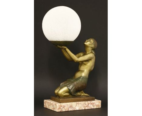 An Art Deco table lamp,the patinated kneeling figure holding a crackled glass globe shade, signed 'FAVRILE' to the side, with