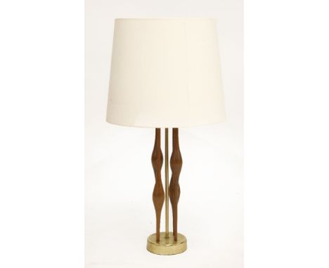 A brass and wood table lamp,1960s, by Stiffel, with four turned teak supports, with a lattice moulded uplighter and a contemp