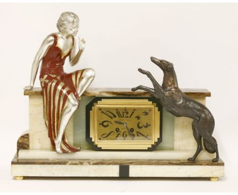 An Art Deco marble and onyx mantel clock, mounted with a lady and a dog either side of the rectangular dial, inscribed 'Desol