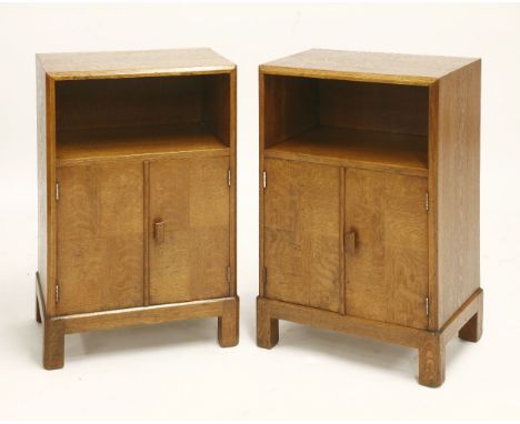 A pair of Heal's oak bedside cabinets,each with a shelf over a parquetry cupboard, with a 'Heal and Son London' ivorine label