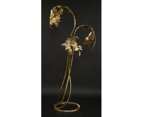 A brass three-branch standard lamp,designed by Tommaso Barbi, 1970s, each branch issuing with embossed leaves forming the sha