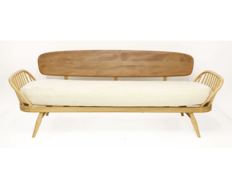 An Ercol studio couch,208cm wide, anda pair of stick back armchairs,with modern upholstered cushions (3)