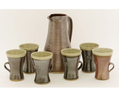 Leach Pottery,a Festival of Britain lemonade set, comprising a set of six beakers and a jug, each with an oval plaque '1951',