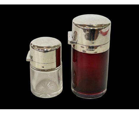 Two silver topped toilet bottles, ruby glass Birmingham 1911, 10.5cm and other Birmingham 1891.