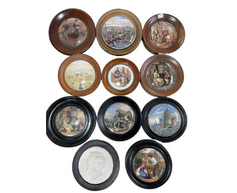 Collection of ten Pratt Ware pot lids in wooden surrounds and R Wagner plaque.