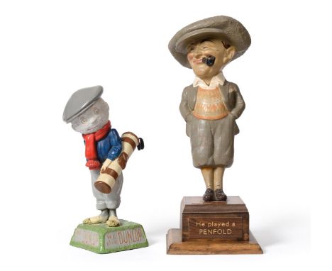 Penfold Golf Ball Advertising Figure in vulcanised rubber, dressed in plus fours and a large cap and smoking a pipe, on woode