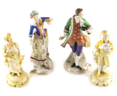 A pair of 20thC Sitzendorf figures of a lady and gentleman, each dressed in finery polychrome decorated predominantly in purp