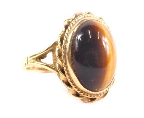 A 9ct gold tiger's eye dress ring, set with oval stone, size J, 4.1g all in.