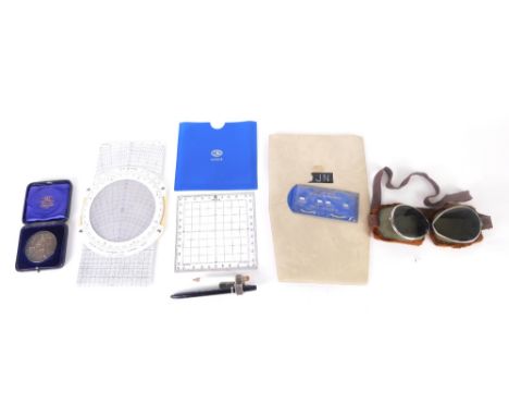 A pair of vintage flying goggles, fur lined with tinted shades, an Airtour plastic gauge, Air Tour guide and a British Dairy 