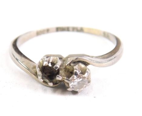 A crossover ring, set with one small claw set stone, (one lacking), white metal marked 18ct, 7g all in.