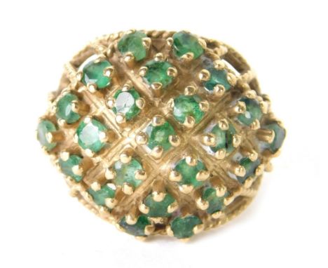 A 9ct gold filigree dress ring, claw set with small green stones in a basket setting, size M, 5.7g all in.