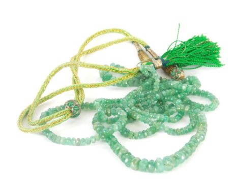 A Middle Eastern jade necklace, the two strand faceted jade beaded necklace, with a green and gilt thread, adjustable necklac