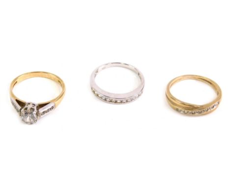 Various dress rings, a half eternity marked 925 set with small white stones, a crossover ring and a solitaire, size O. (3)