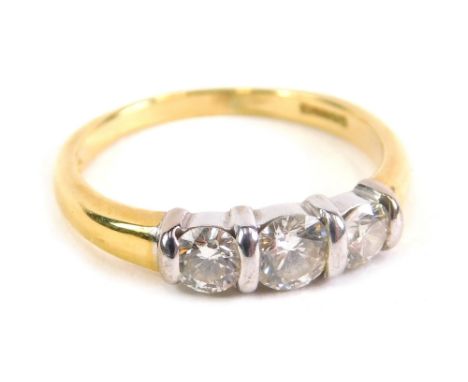 An 18ct gold three stone diamond ring, on plain shank, size M, 3.4g all in.