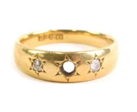 An 18ct gold dress ring, inset with two small white stones (one lacking) size L, 3.9g all in.