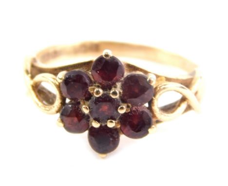 A 9ct gold dress ring, claw set with a floral arrangement of red stones, size J, 2.2g.