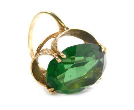 A 9ct gold dress ring, claw set with green stone, size K, 6.1g all in.