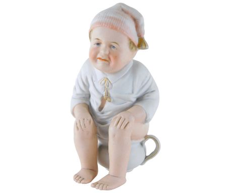 An early 20thC bisque porcelain figure of a child, seated on chamber pot, 19cm high.