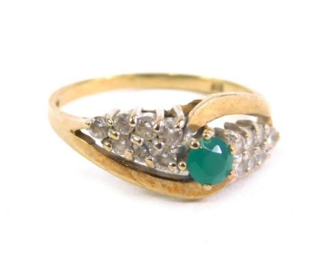 A 9ct gold dress ring, claw set with central green stone flanked by banks of white stones, size O, 2.3g all in.