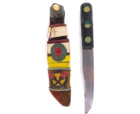 A mid 20thC Boy Scout's dagger, in sheath with Boy Scouts fox head badge, with plain blade and turned handle, 24cm long. 