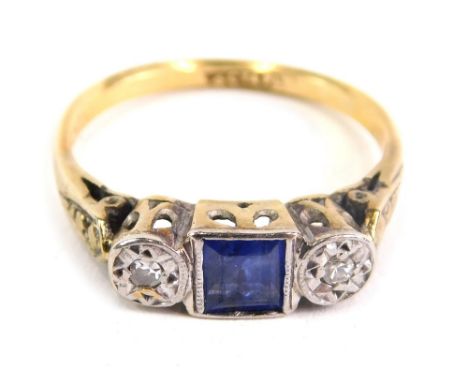 An 18ct gold dress ring, with baguette cut blue stone flanked by two small diamonds, size J, 2.3g.