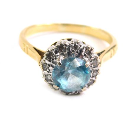 A blue zircon and diamond dress ring, illusion set with claw set central stone, marked 18ct, size M, 3.6g all in.