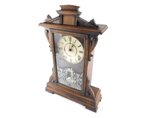 An early 20thC oak stained architectural mantel clock, with 13cm diameter dial stencilled with Roman numerals, with a glazed 