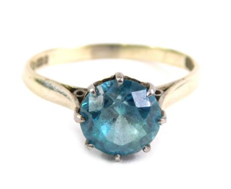 A 9ct white gold dress ring, claw set with blue zircon, size O, 2.6g all in.