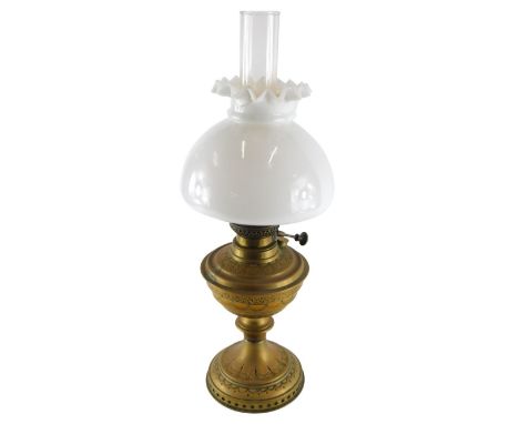 A brass oil lamp, with milk glass shade, clear reservoir and brass stem, 47cm high. (AF) 