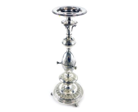 A late 19thC silver plated ecclesiastical candlestick, with orb and egg stem, on a circular foot with scroll feet set with an