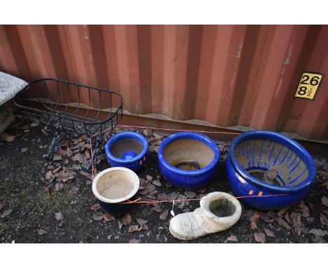 A SET OF THREE GRADUATING GLAZED PLANTERS, diameter 44cm x height 27cm, another glazed plant pot, a shoe shaped garden items 