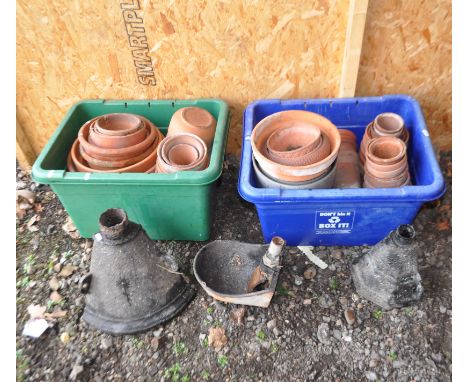 TWO TRAYS CONTAINING TERRACOTTA AND OTHER PLANT POTS, along three vintage cast iron items including two rain hoppers and a ca