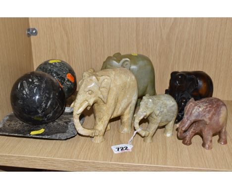 A GROUP OF ELEPHANT SCULPTURES AND CARVED SPHERES comprising two carved hardstone larger elephants height 13cm x length 15cm,