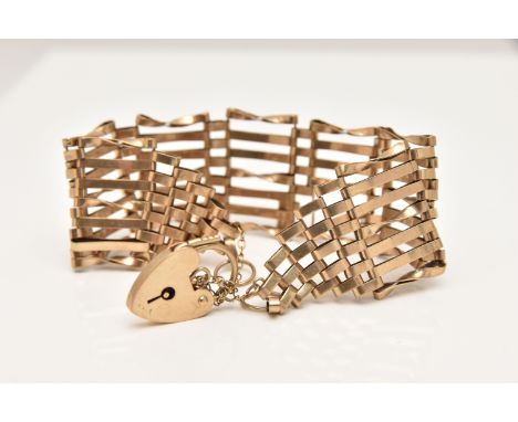 A 9CT GOLD GATE BRACELET, wide yellow gold gate bracelet, fitted with a heart padlock bracelet, hallmarked 9ct London, approx