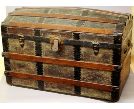 Wood and metal trunk on castors with leather inlay, domed lid, lift-out tray