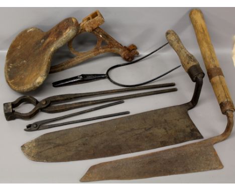 Two scythes, iron implements and a wooden tractor seat