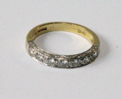 Diamond half eternity ring with seven brilliants in engraved 18ct gold.