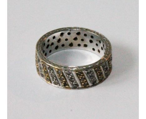 Eternity ring with diagonally-set bands, each of three eight-cut diamonds, in yellow and white gold, 1970s.