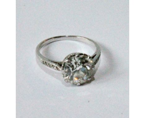 Diamond solitaire ring, the old-cut brilliant, approximately 4ct, with diamond-set shoulders and scrolling, coronet setting, 